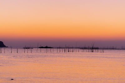 Scenic view of sea against orange sky