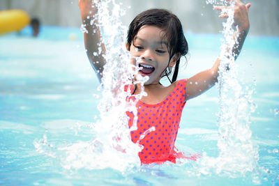 Close-up of cute playful girl at water park