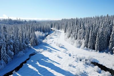 Snow covered landscape against clear sky