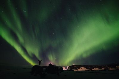 Low angle view of aurora polaris against sky at night