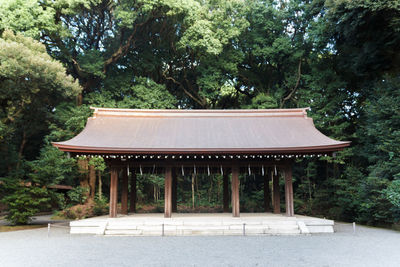 Gazebo in park against trees in forest