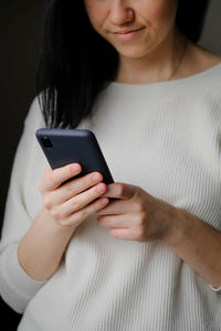 Girl holds a smartphone in her hands. touch screen smartphone, in hand. businesswoman 