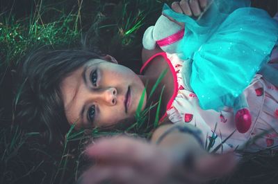 Portrait of girl lying on grass
