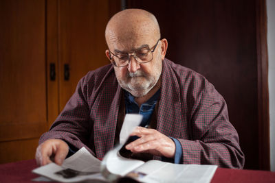 Mature man sitting by table