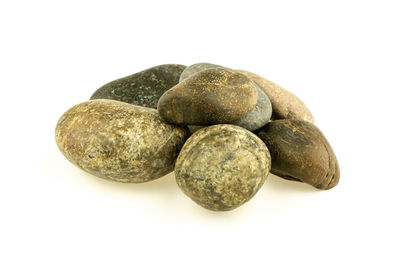 Close-up of pebbles against white background