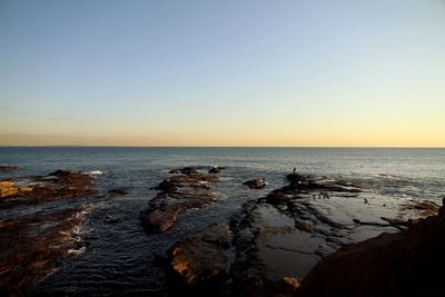 Scenic view of calm sea at sunset