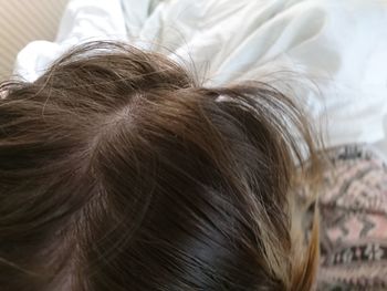 Close-up of woman with hair on bed