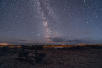 Scenic view of field against sky at night