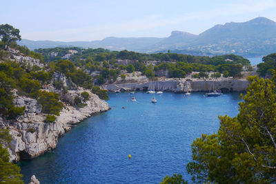 Scenic view of sea and mountains against sky