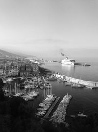 High angle view of harbor and buildings against sky