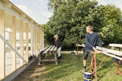 Man and woman talking while making shed at farm