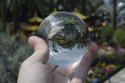 Close-up of hand holding crystal ball