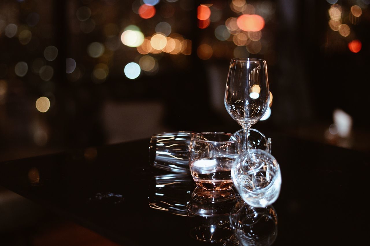 illuminated, close-up, focus on foreground, no people, indoors, reflection, wineglass, christmas lights, drink, night, crystal glassware, alcohol