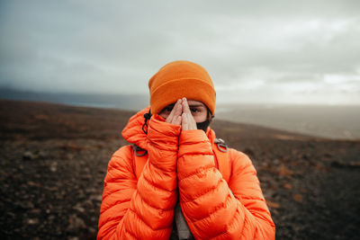 Young tourist near land and water on blurred background