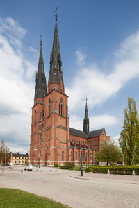 Low angle view building against cloudy sky