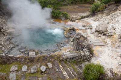 Boiling water and steam venting hot spring in furnas, sao miguel island in azores, portugal