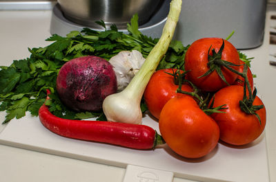 Close-up of vegetables on cutting board in kitchen