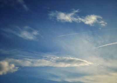 Low angle view of vapor trails in sky