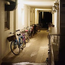Bicycles parked in illuminated city at night