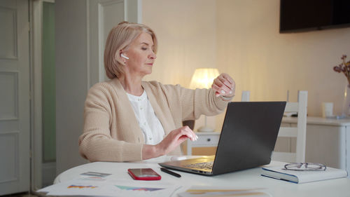 Young woman using laptop at office