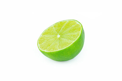 Close-up of lemon slice over white background