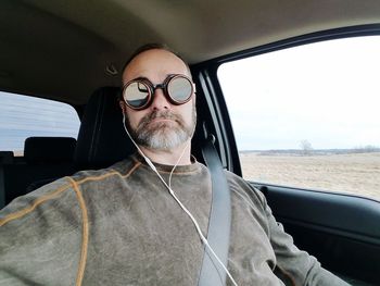 Portrait of man sitting in car