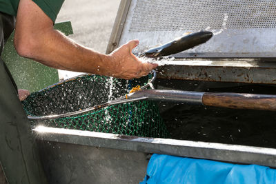 Low section of man working in water