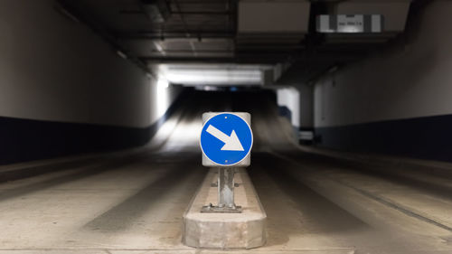 Blue traffic sign with directional arrow and two lanes