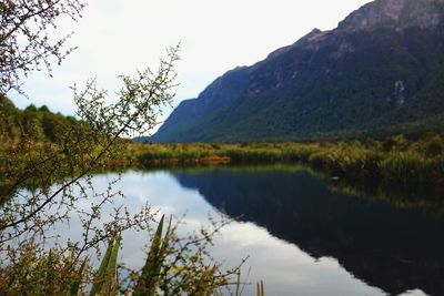 Scenic view of lake and mountains against sky