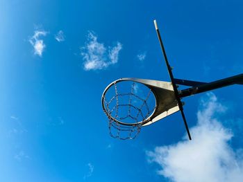 Low angle view of basketball hoop against blue sky