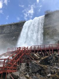 Scenic view of waterfall against sky