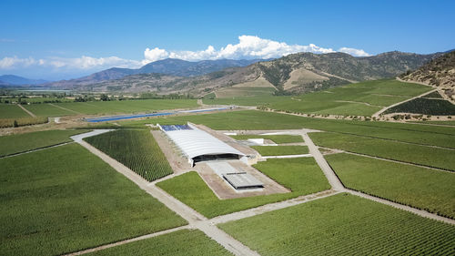 Scenic view of field and mountains against sky