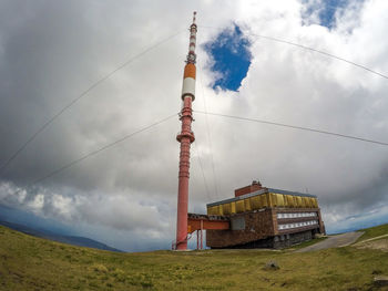 Low angle view of communications tower against sky