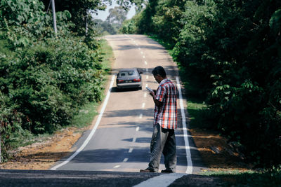 Man using mobile phone while crossing road