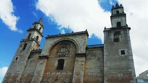 Low angle view of bell tower against cloudy sky