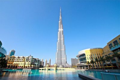 View of built structures against clear blue sky