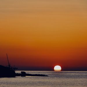 Scenic view of sea against orange sky
