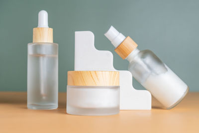 Set of cosmetic products in frosted glass bottles on cocnrete podiums. skin care unbranded mocup 