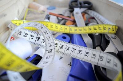 High angle view of measuring tape and work tools on table