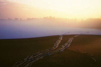 Scenic view of land against sky during sunset