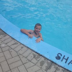 High angle view of boy swimming in pool