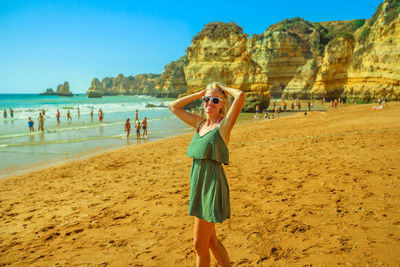 Portrait of woman standing at beach