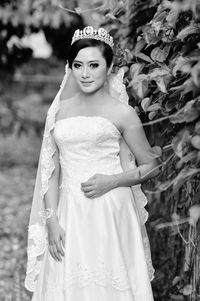 Young bride standing by plants