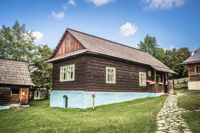 House by building against sky