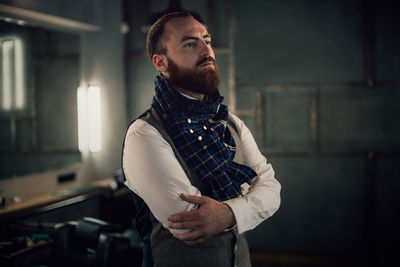 Mid adult bearded man standing in hair salon