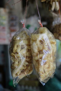 Close-up of fruits hanging in market for sale