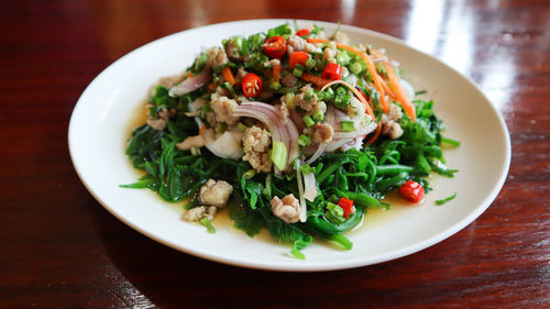 Spicy paco fern salad, small vegetable healthy food with minced pork, mixed vegetable thai herb.