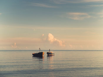 Boat amidst sea against sky