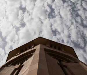 Low angle view of building against cloudy sky