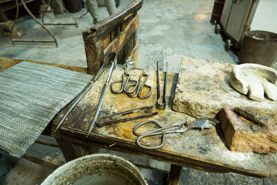 High angle view of work tools on wooden table at factory